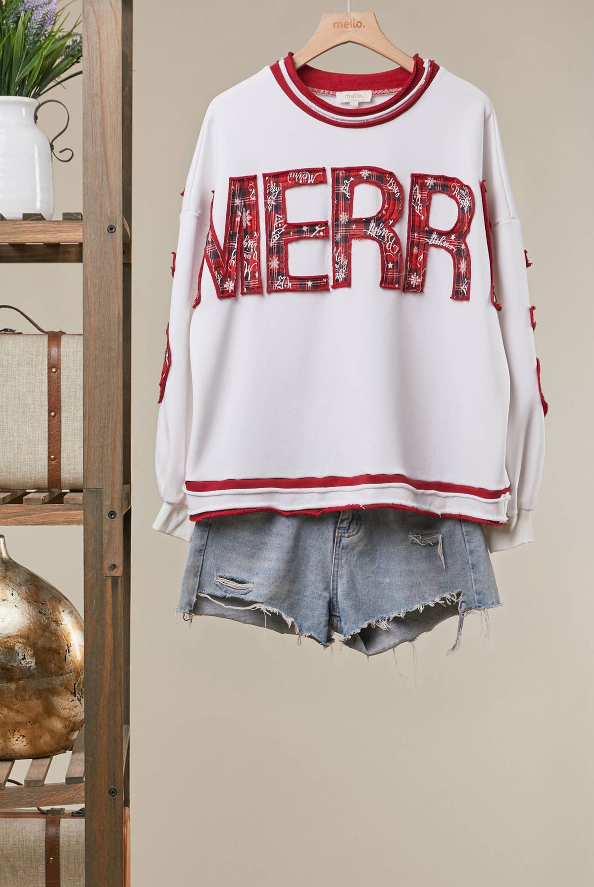 Mello Tuesday Holiday Merry Christmas letter sweatshirt featuring festive red and green design with holiday-themed lettering.