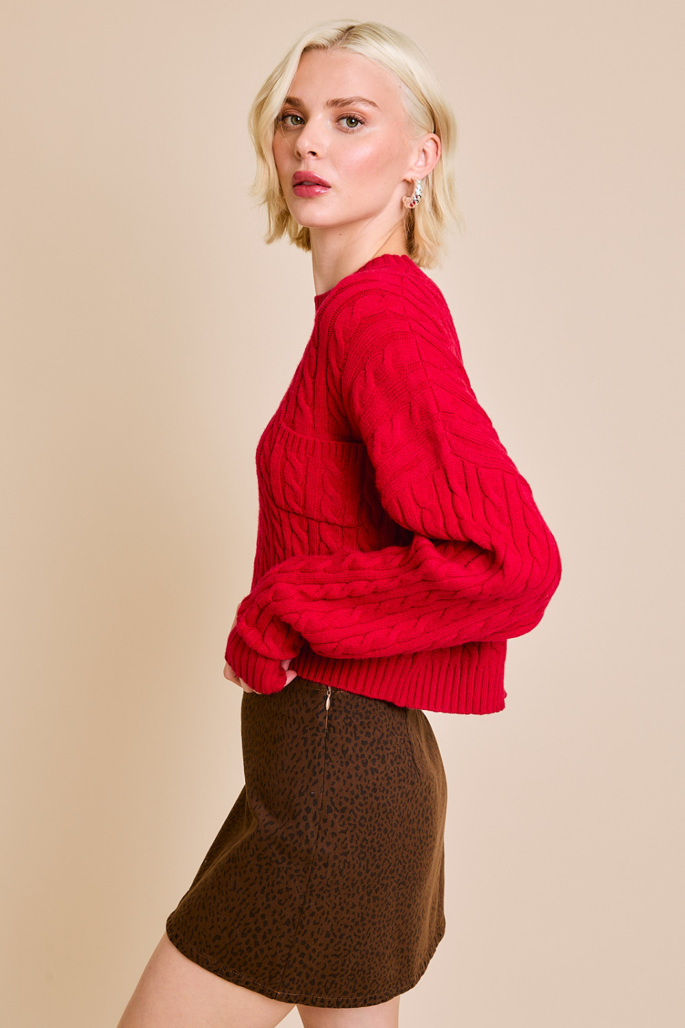 Red RARA Boutique Dolman sleeve cable knit cropped sweater with a front pocket, featuring a cozy, relaxed fit and stylish design.