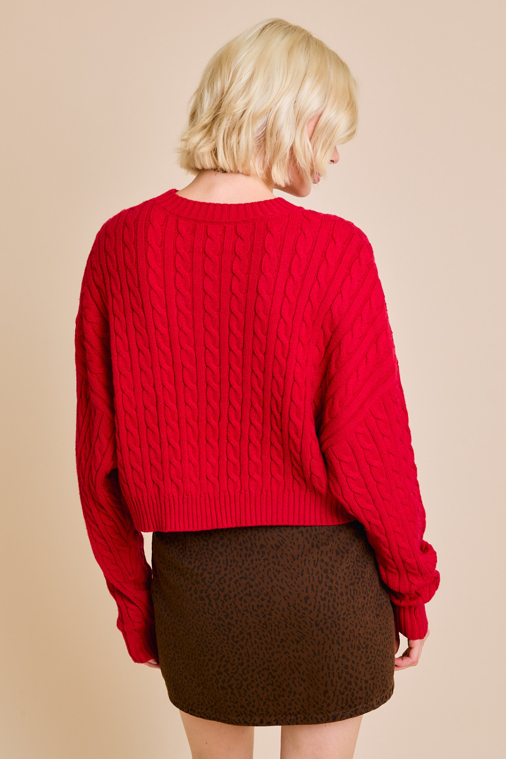 Red RARA Boutique Dolman sleeve cable knit cropped sweater with front pocket, featuring a cozy, stylish design.