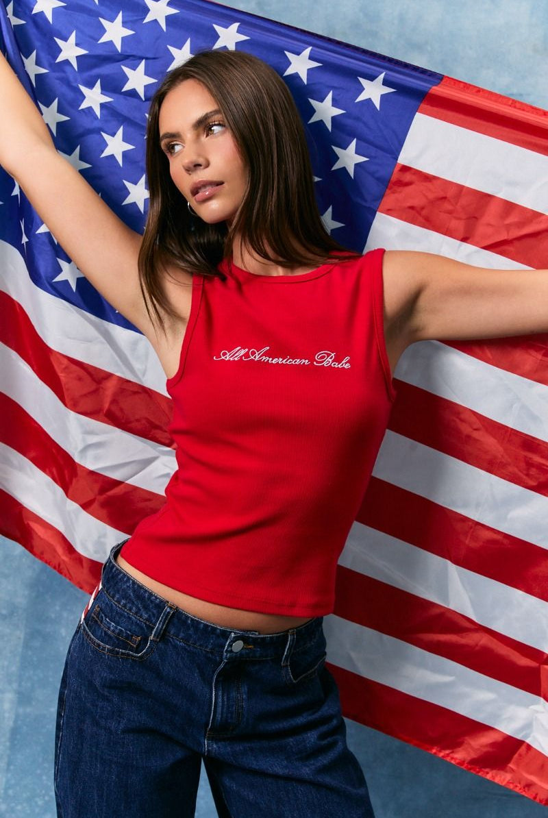Red embroidered All American Babe tank top by RARA Boutique displayed on a hanger with detailed stitching and casual fit.