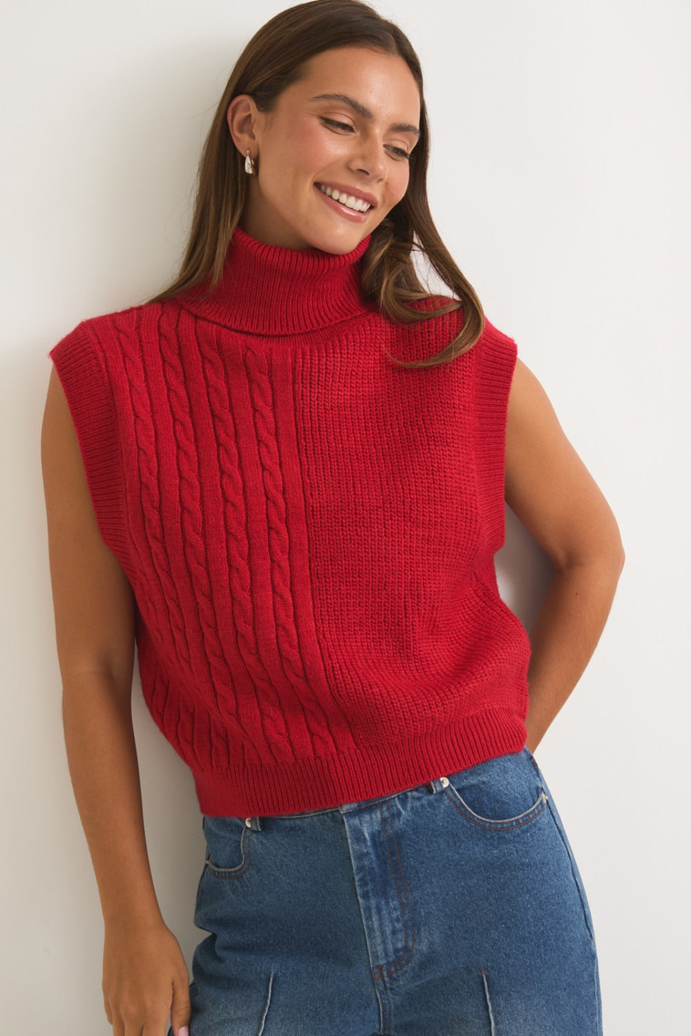 Red ribbed and cable knit turtleneck sweater vest by RARA Boutique, featuring a cozy, textured design and classic fit.