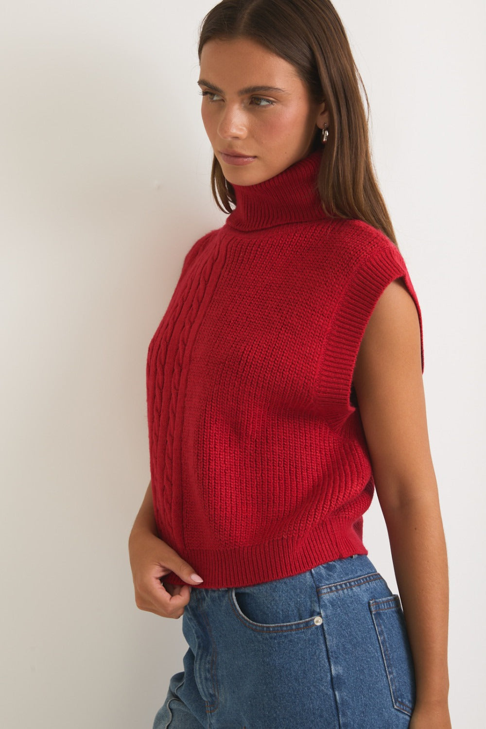 Red ribbed and cable knit turtleneck sweater vest from RARA Boutique, featuring a cozy, fitted design.
