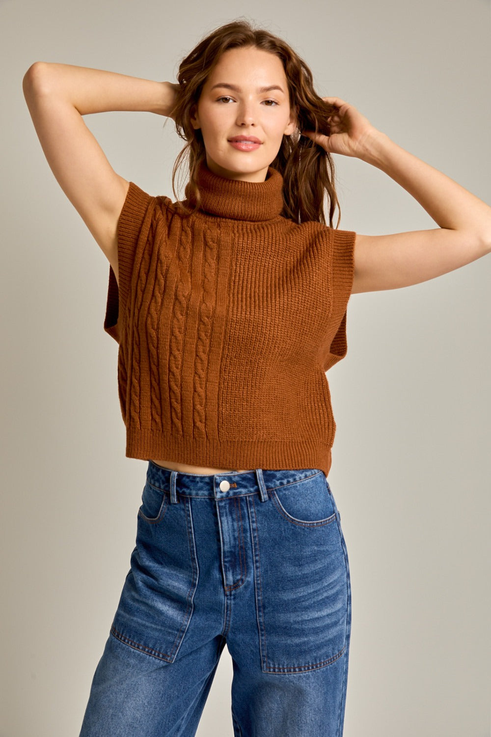 Caramel ribbed and cable knit turtleneck sweater vest by RARA Boutique, featuring a cozy, textured design and sleeveless fit.
