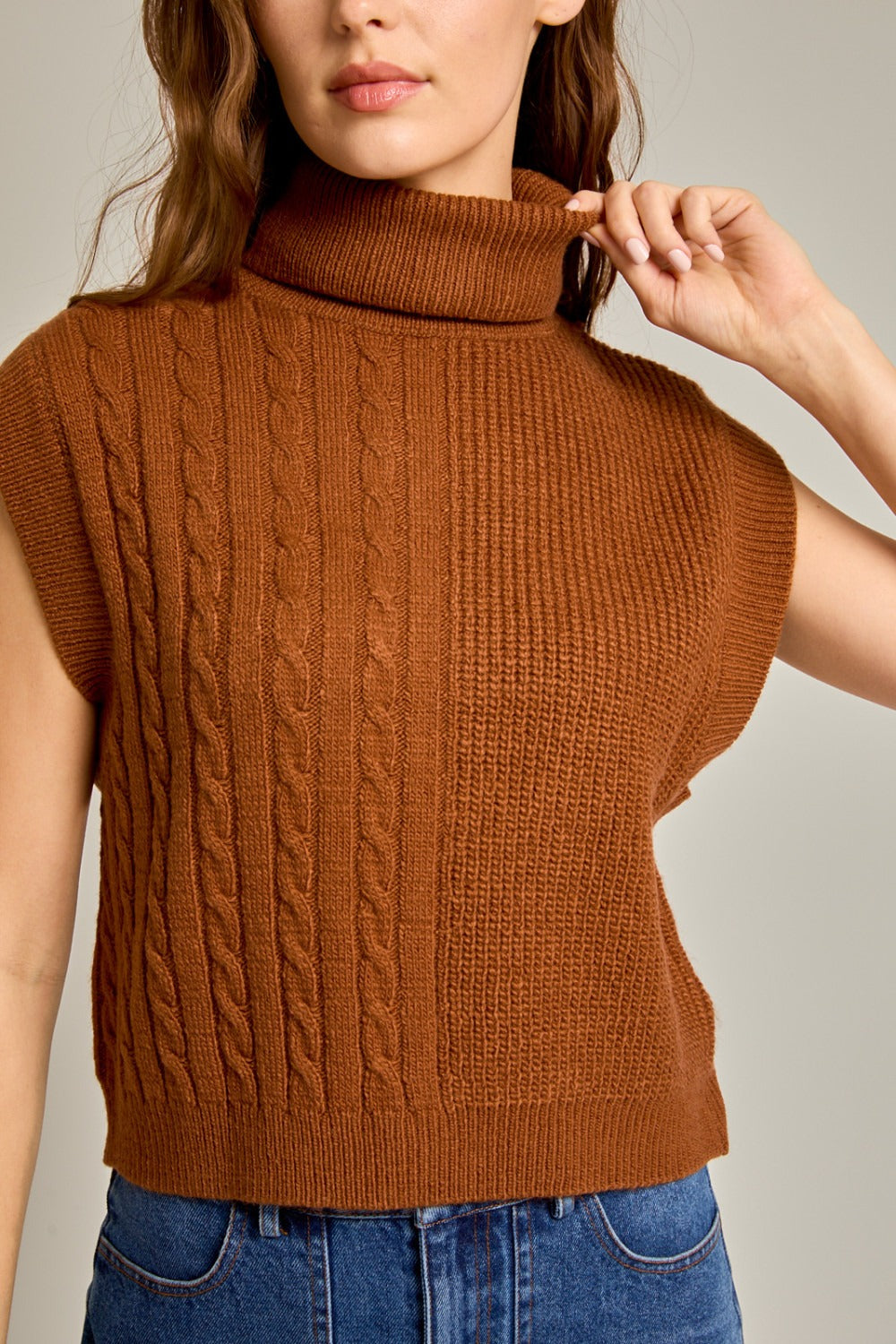 Caramel ribbed and cable knit turtleneck sweater vest by RARA Boutique, featuring a cozy, fitted design and textured knit pattern.
