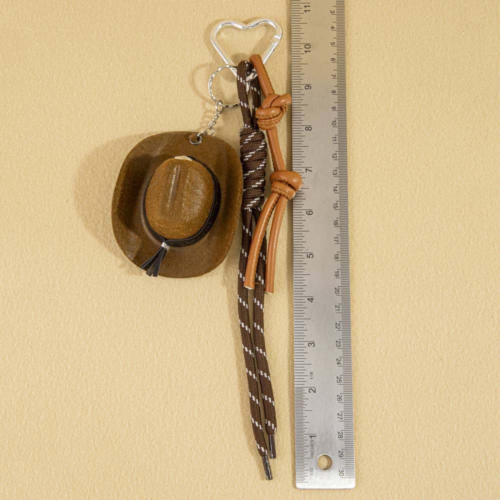 Mini cowboy hat with western rope detail, charm accessory from Collections by Fame Accessories, perfect for bags or keychains.
