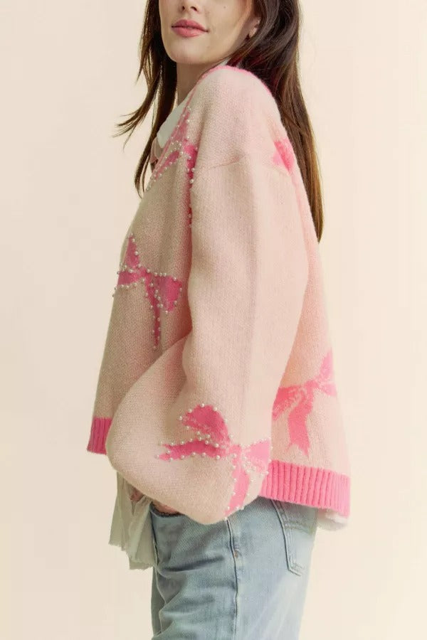 RARA Boutique pearl studded bow balloon sleeve V-neck sweater with a stylish design, perfect for casual and chic outfits.