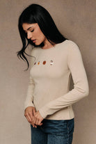 Round neck long sleeve ribbed top with fall-themed embroidery by Sunday Edition, featuring autumn-inspired designs.