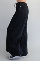 Wide leg slouchy denim pants with drawstring waist by RARA Boutique, featuring relaxed fit, casual style, and classic blue denim fabric.