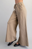 Wide leg slouchy denim pants with drawstring waist by RARA Boutique, featuring a relaxed fit and casual style.