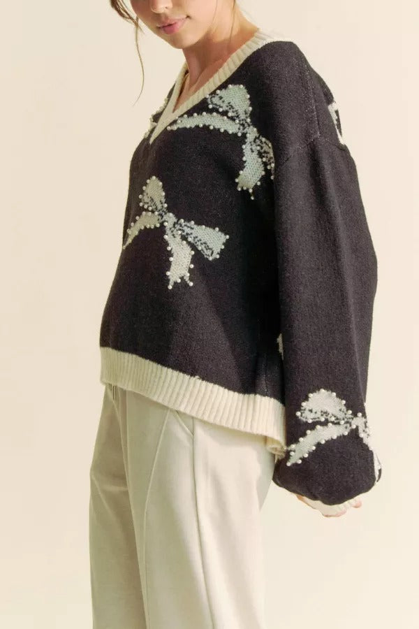 RARA Boutique pearl studded bow balloon sleeve V-neck sweater with elegant design and textured fabric, perfect for stylish casual wear.