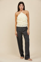 RARA Boutique tiered ruffle halter neck tank top with layered fabric and halter straps, displayed on a hanger.
