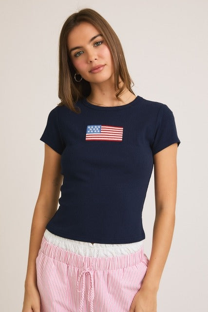 Ribbed baby tee by RARA Boutique featuring embroidered American flag design, soft cotton fabric, and short sleeves.