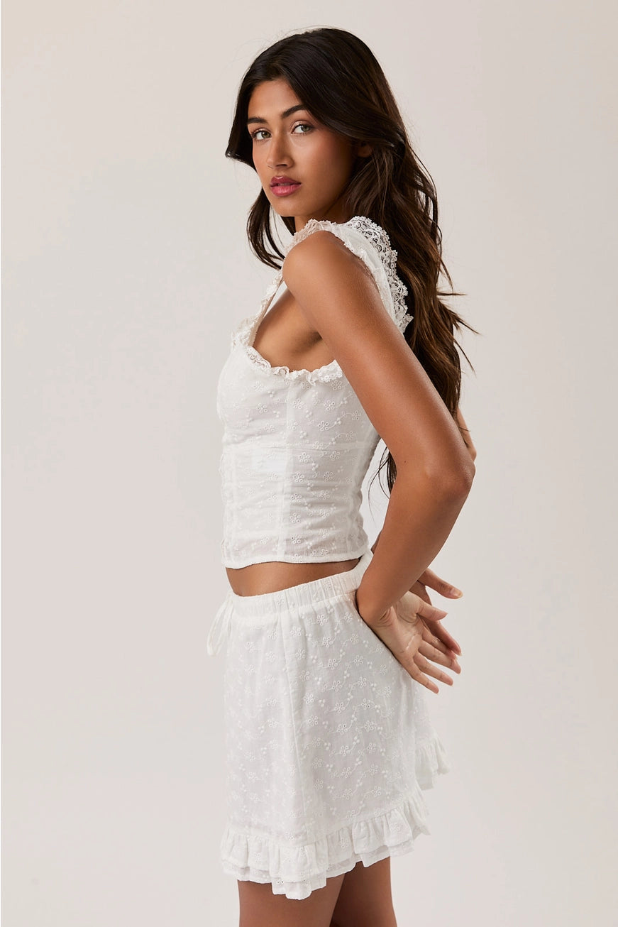 RARA Boutique sleeveless blouse with eyelet lace trim and square neckline, featuring a stylish, feminine design.