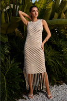RARA Boutique cowrie shell fringe open-knit dress showing a flowy boho style with shell accents and lightweight knit fabric.