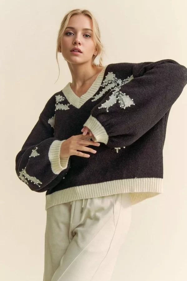 RARA Boutique pearl studded bow balloon sleeve V-neck sweater with elegant design and soft knit fabric, displayed on a mannequin.