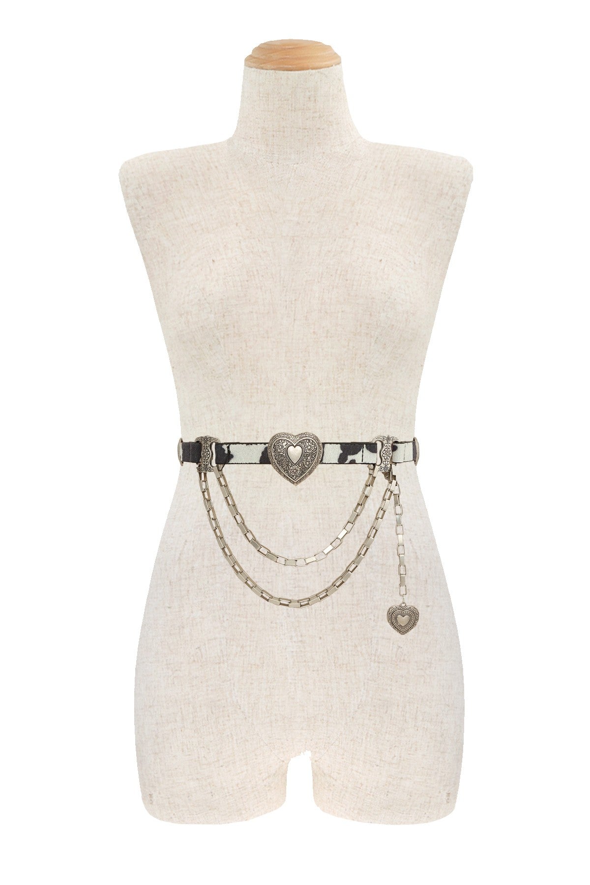 Western cowhide chain belt with engraved heart concho from RARA Boutique, showcasing detailed metal accents and genuine leather.