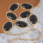 Oval stone gold frame chain belt with elegant design, featuring oval stones and a gold chain for stylish waist accessory.
