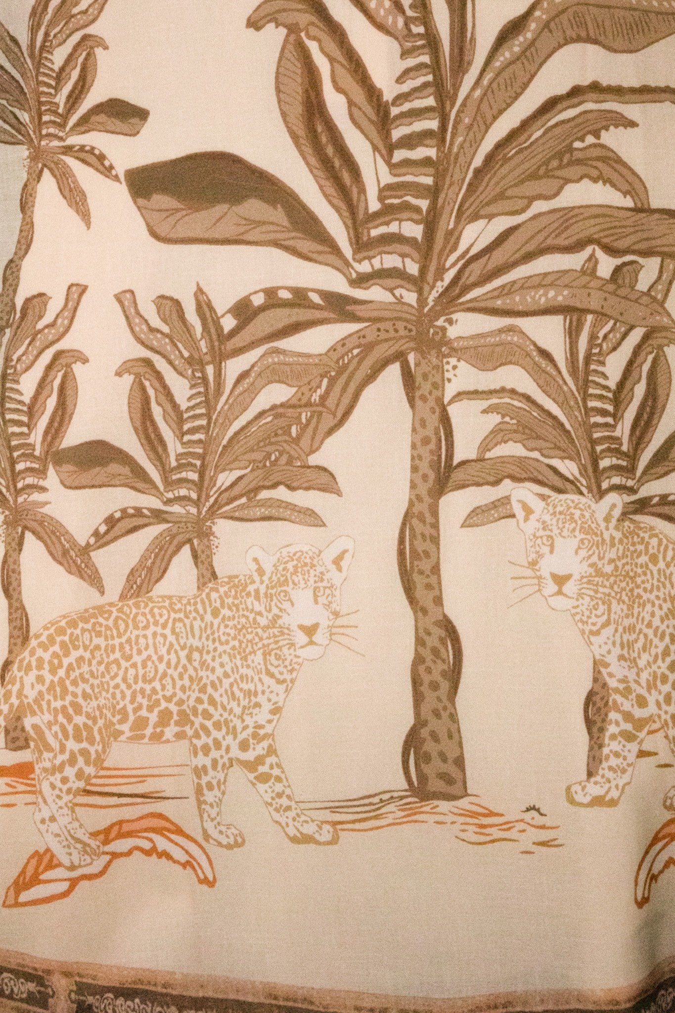 Tropical palm and leopard print maxi skirt by RARA Boutique in peach, flowing fabric with vibrant pattern details.