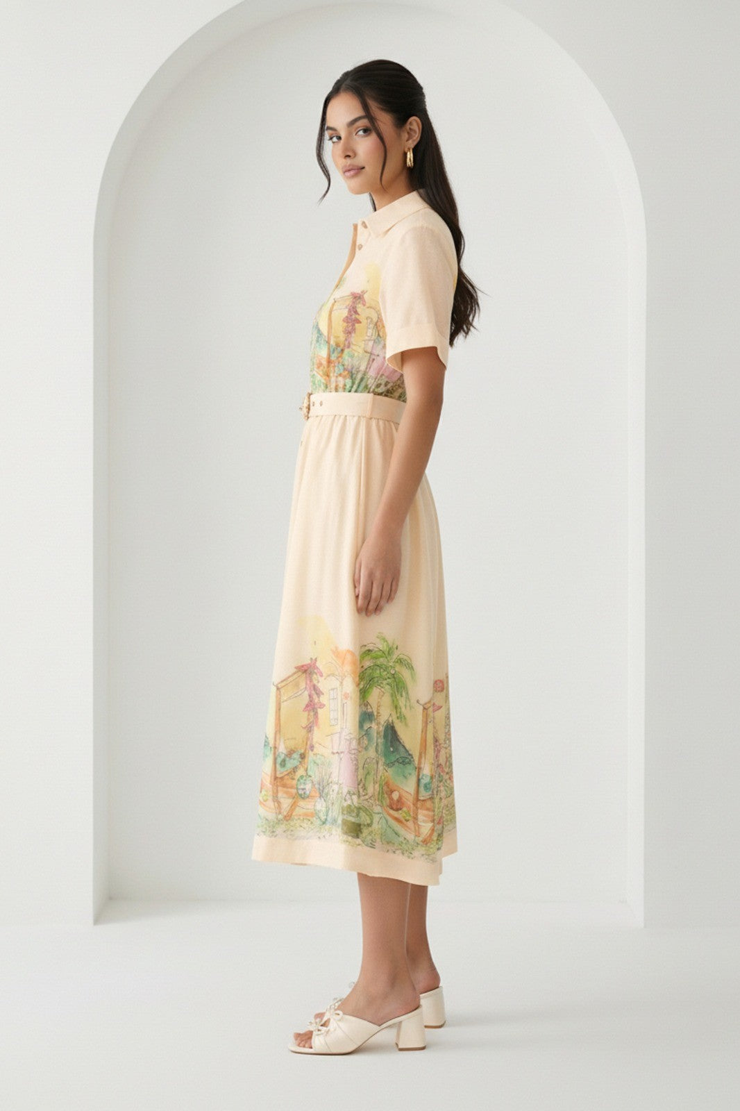 Watercolor village print belted midi dress by RARA Boutique in peach, featuring a flowy design and watercolor landscape pattern.