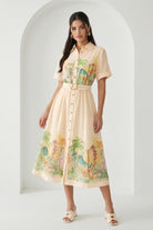 Watercolor village print belted midi dress by RARA Boutique in peach, featuring a flowy silhouette and watercolor landscape design.