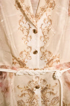 RARA Boutique watercolor floral baroque border blouse with belt, peach-colored button-down top featuring floral and baroque design elements.