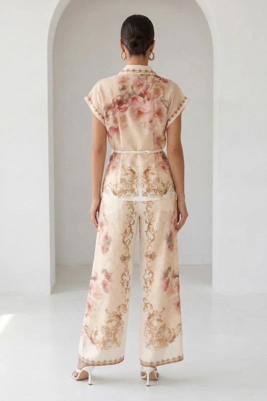 Watercolor floral baroque border wide-leg pants in peach by RARA Boutique, featuring flowing fabric and elegant floral patterns.