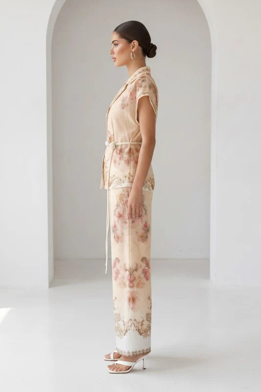 Watercolor floral baroque border wide-leg pants by RARA Boutique in peach with flowing fabric and intricate floral patterns.