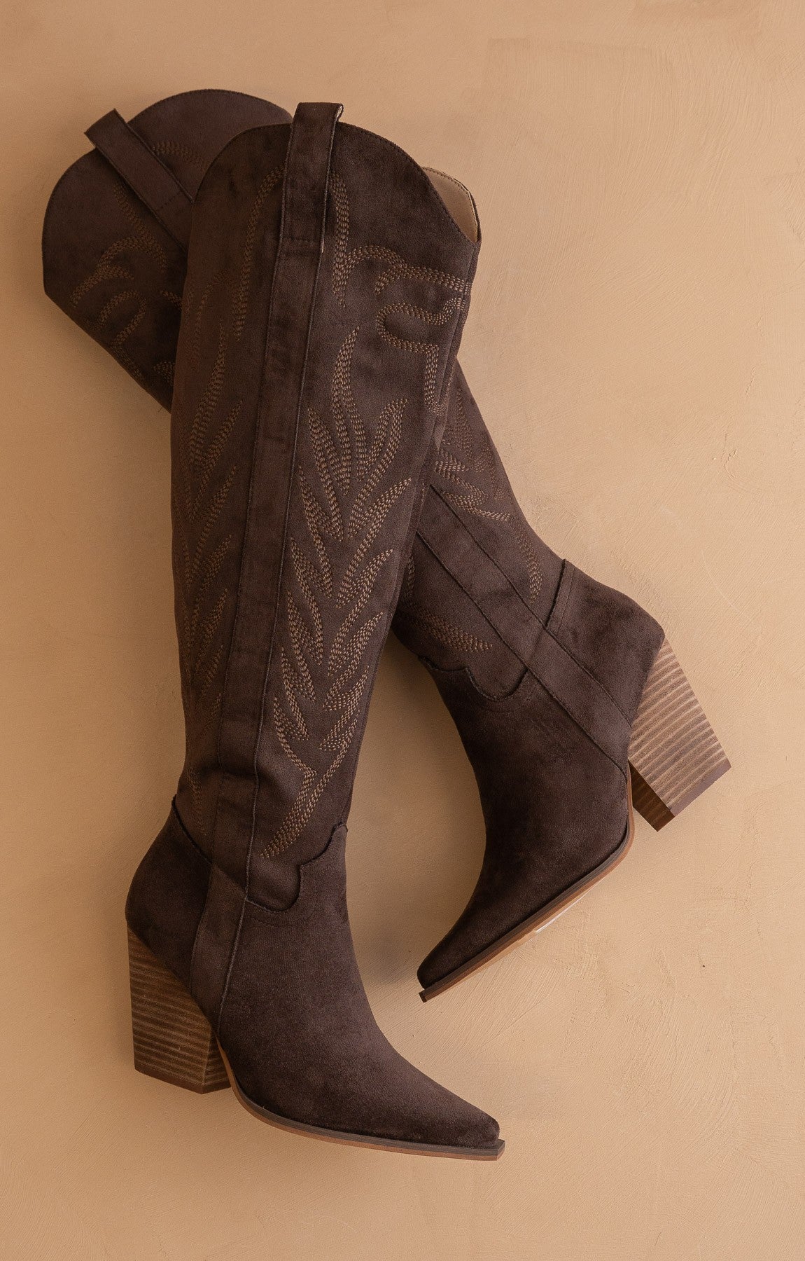 Tall knee-high western embroidered pointed toe boots by RARA Boutique featuring intricate embroidery and a stylish western design.