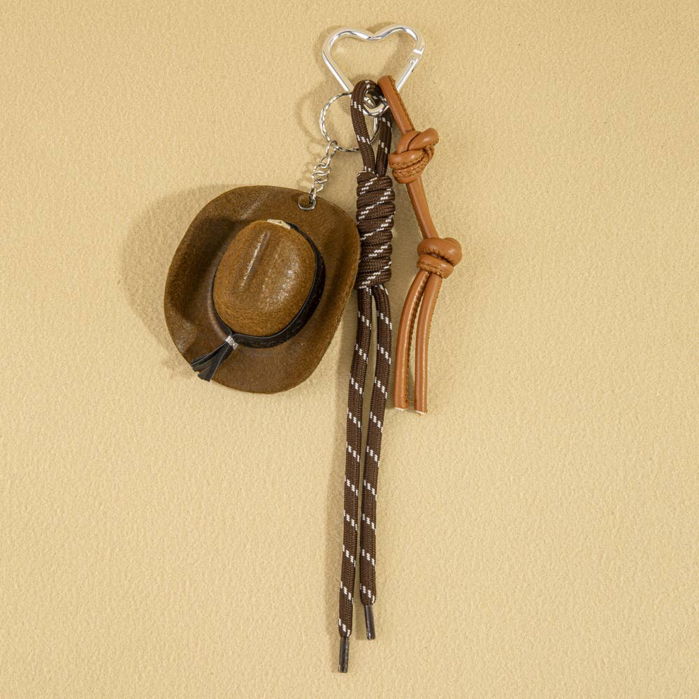Mini cowboy hat western rope bag charm with gold accents, featuring a rustic cowboy style accessory for bags and keychains.