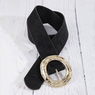 Suede hammered round buckle belt from Collections by Fame Accessories, showing close-up of textured suede strap and round metal buckle.