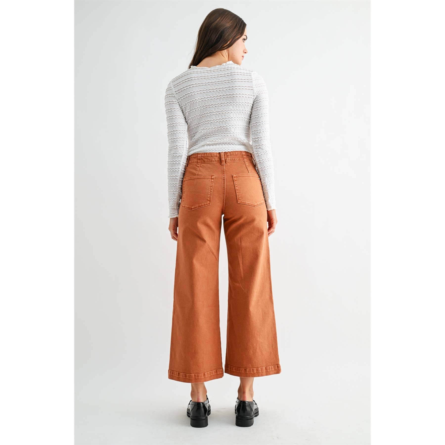 High-rise wide crop patch pocket jeans by Mica Denim, featuring distressed details and classic denim texture.