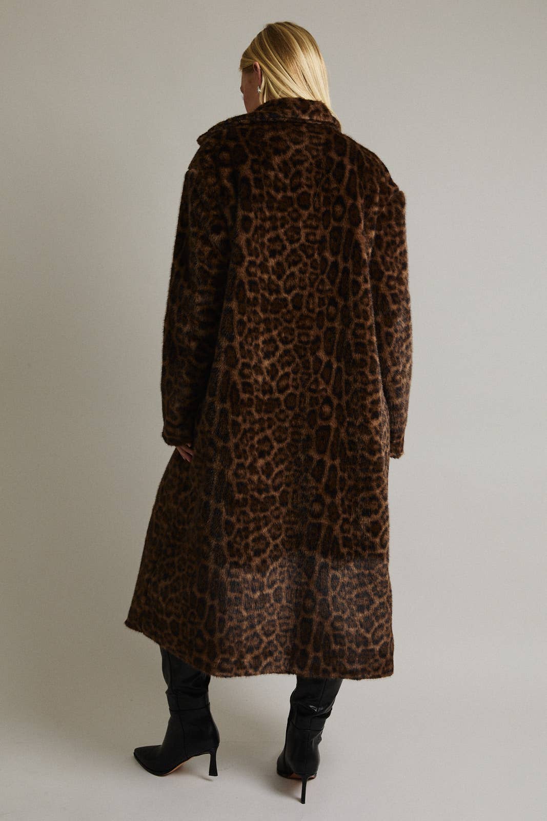Le Lis faux fur long coat jacket with plush texture and collar, stylish winter outerwear displayed on a hanger.