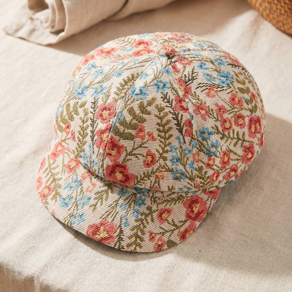 Floral tapestry newsboy cabbie hat by Collections by Fame Accessories, featuring colorful floral fabric and classic newsboy style.
