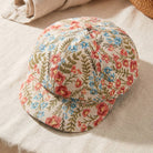 Floral tapestry newsboy cabbie hat by Collections by Fame Accessories, featuring colorful floral fabric and classic newsboy style.