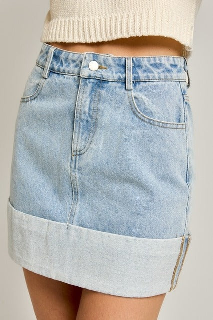 High waisted cuffed hem denim mini skirt from RARA Boutique, featuring a classic blue wash and stylish cropped hem.
