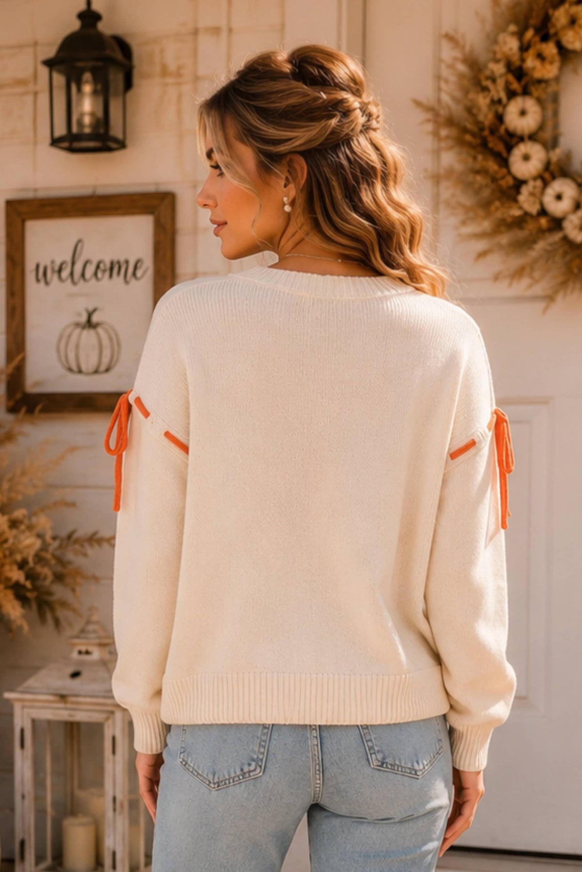 Main Strip thankfulness pumpkin graphic tie-sleeve sweater featuring fall-themed design and cozy knit fabric.