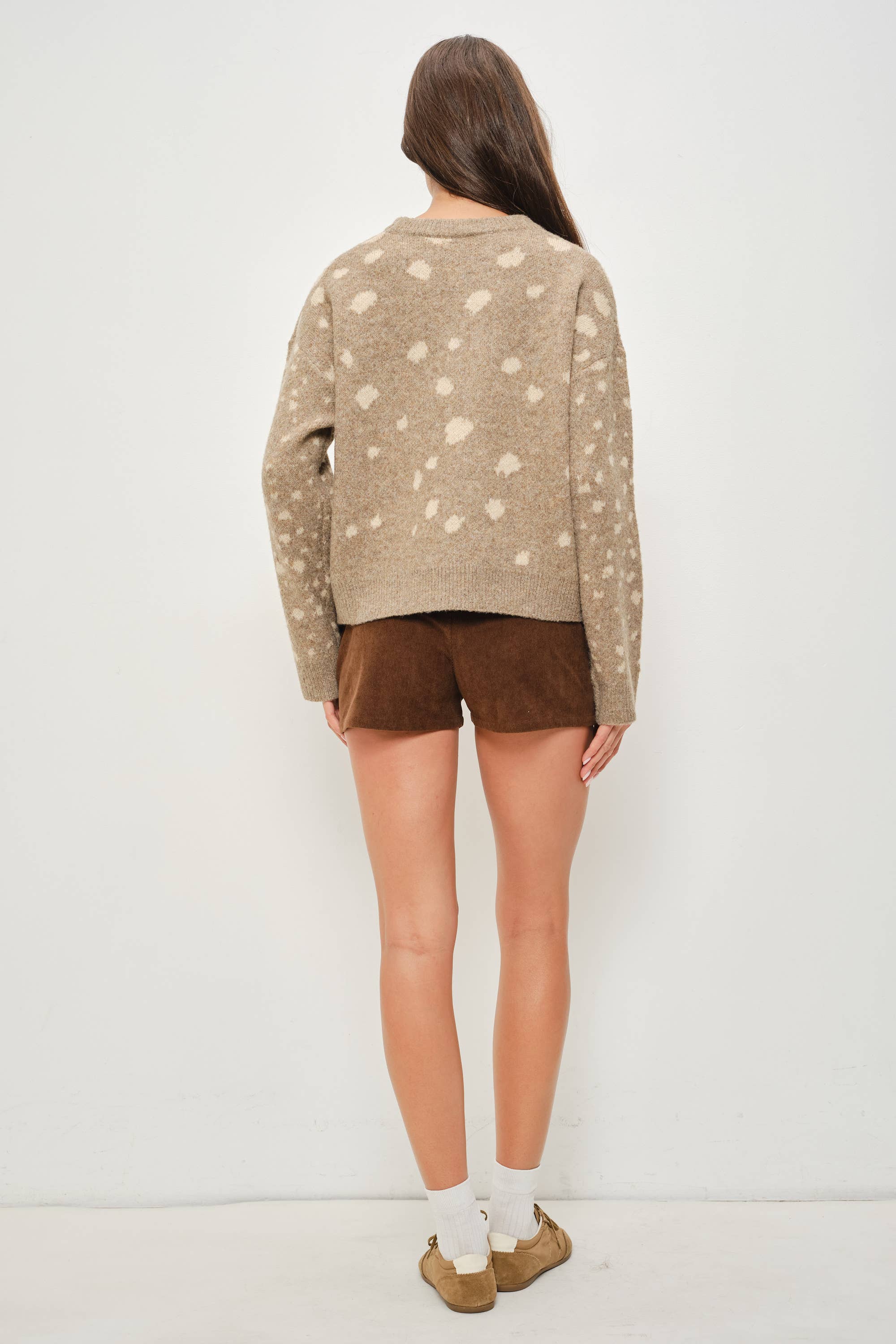 Pretty Garbage Tuesday deer print sweater featuring a cozy knit fabric and a charming deer graphic design.