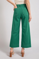Light blue soft wash wide leg jeans from RARA Boutique with a relaxed fit and high waist, displayed on a hanger.