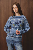 LE LIS long sleeve crew neck cowboy graphic sweater showing a detailed cowboy design on the front.