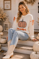 Main Strip thankful pumpkin graphic tie-sleeve sweater featuring a fall-inspired design and cozy knit fabric.