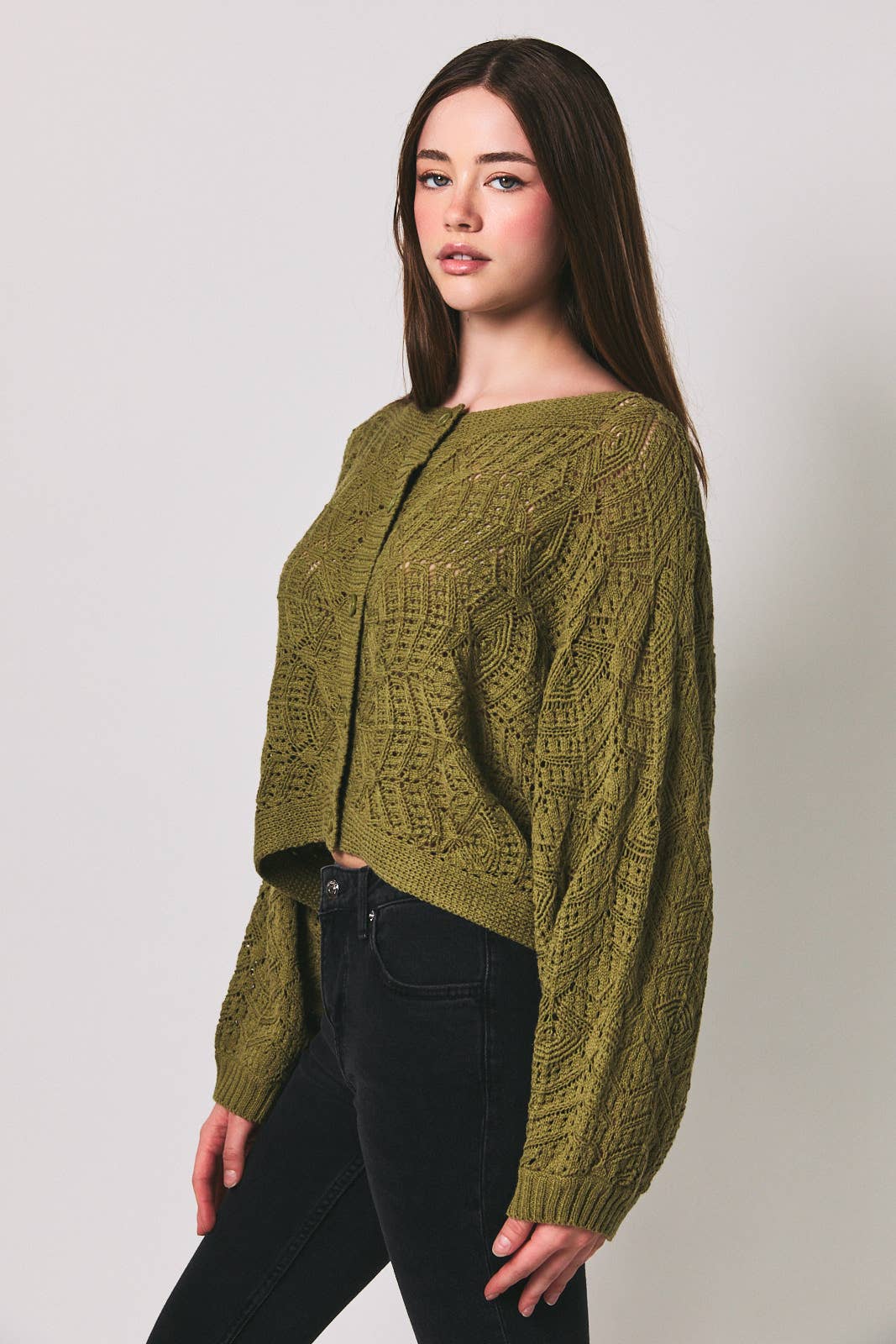 Long sleeve crochet cardigan by LE LIS featuring intricate knit patterns and a relaxed fit, displayed on a neutral background.