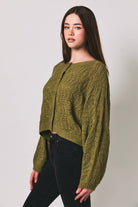 Long sleeve crochet cardigan by LE LIS featuring intricate knit patterns and a relaxed fit, displayed on a neutral background.