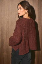 LE LIS oversized cropped cable knit sweater displayed on a model, featuring chunky knit texture and relaxed fit in neutral tones.