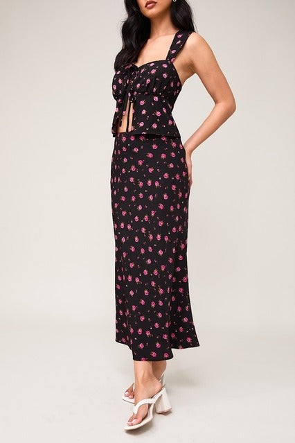 High waisted floral rose print bias midi skirt from RARA Boutique, featuring a flowy silhouette and vibrant flower pattern.