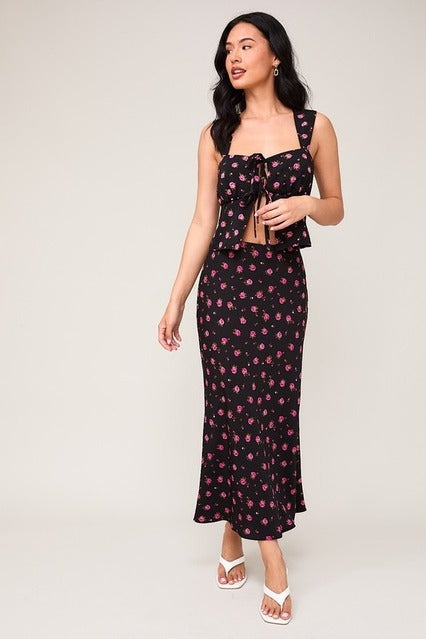 High waisted floral rose printed bias midi skirt from RARA Boutique featuring a flowy silhouette and vibrant rose pattern.
