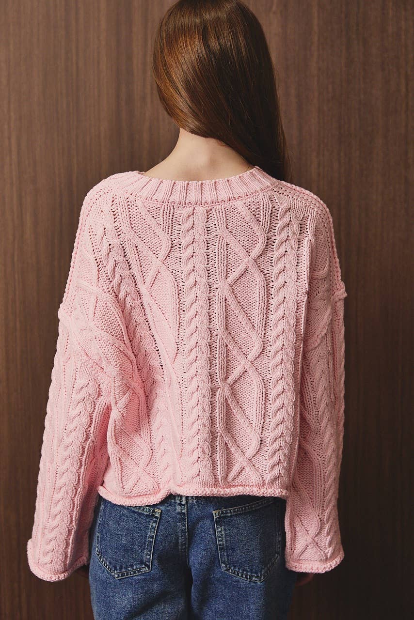 LE LIS oversized cropped cable knit sweater in cozy textured fabric, featuring a relaxed fit and chunky knit pattern.