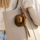 Mini cowboy hat Western rope bag charm with braided details, perfect as a stylish accessory for bags or keychains.