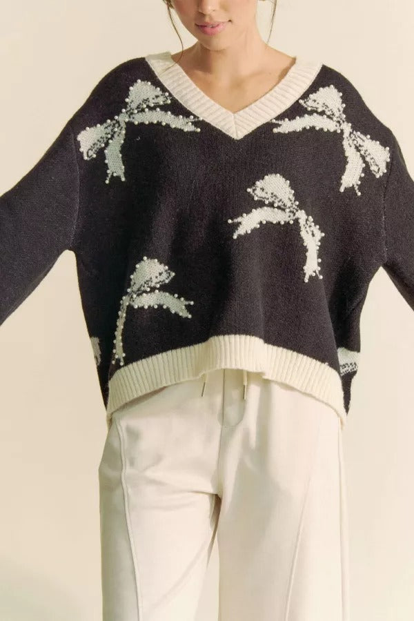Pearl studded bow balloon sleeve V-neck sweater from RARA Boutique, featuring a stylish design and soft knit fabric.