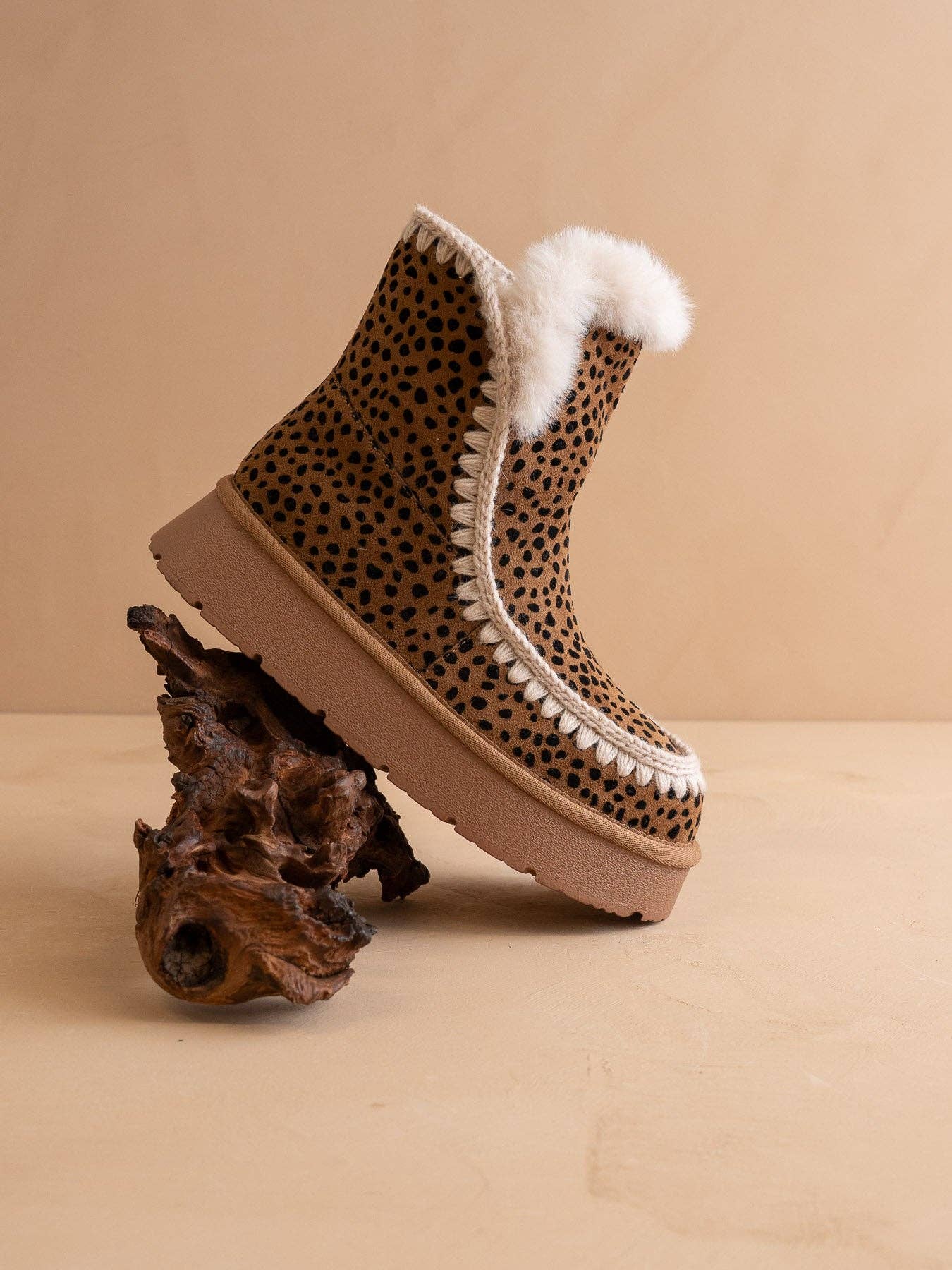 Dark cheetah shearling trim platform winter boot from Oasis Society featuring a sturdy sole and cozy shearling accents.