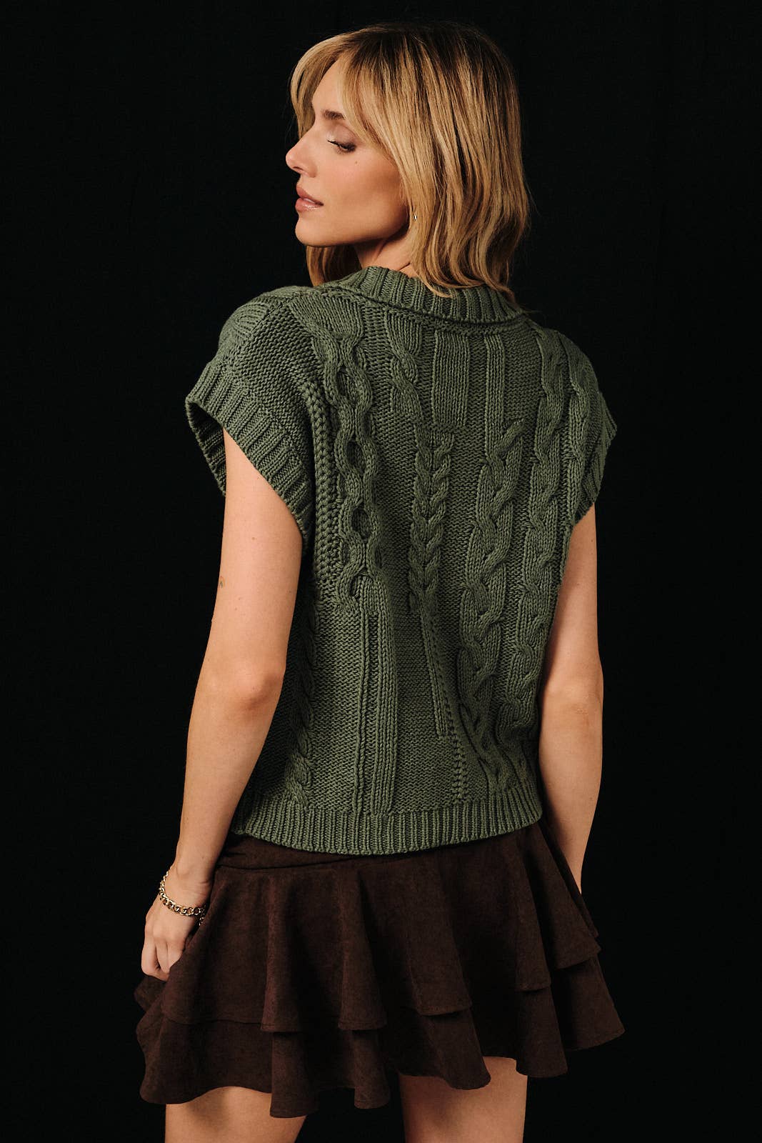 Cable knit button-up sweater vest by Sunday Edition, featuring a classic cable knit pattern and button details in natural tones.